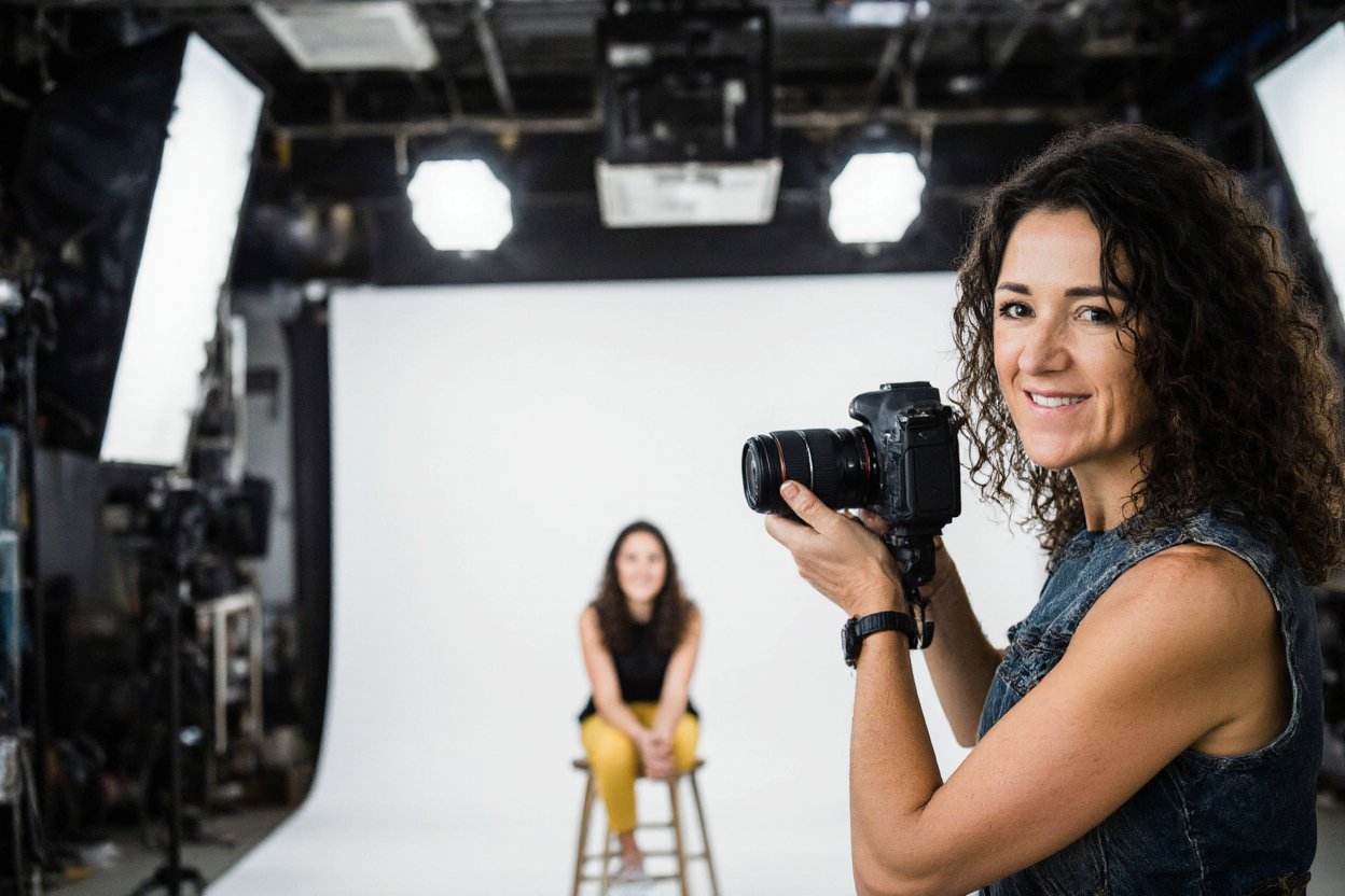 Polly Sheldon holding her camera during a professional studio brand shoot